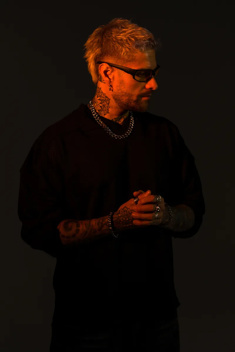 Rafael Cerato wearing sunglasses in a warm-lit studio