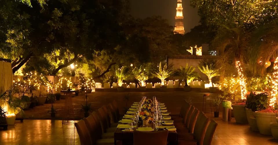 Q’la courtyard dining with the illuminated Qutub Minar beyond